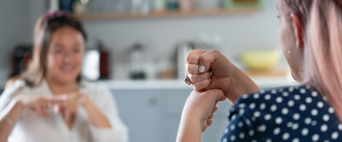 Two people signing