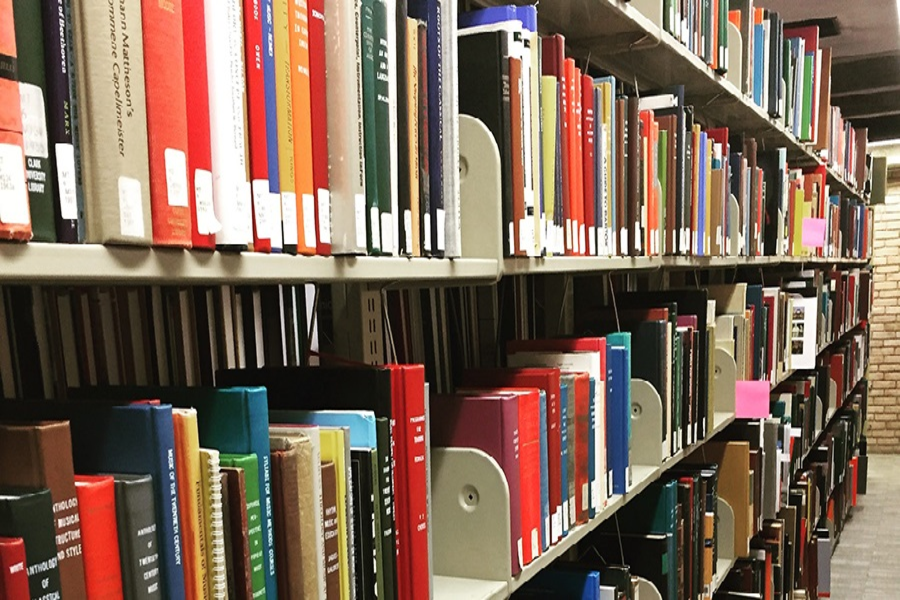 Library setting of books filled with varying colors