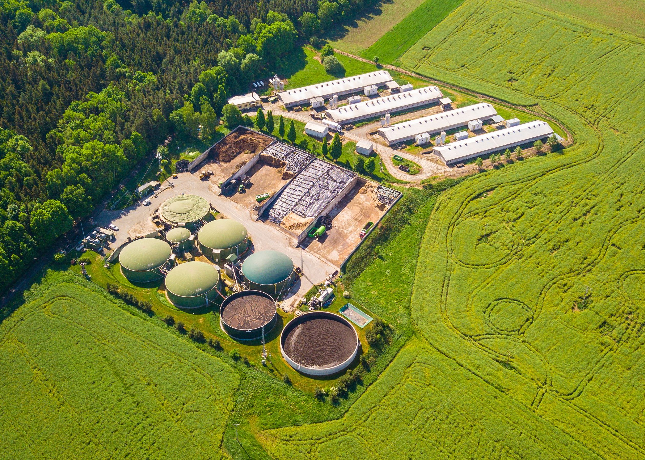 Aerial view of a biomethane plant near a farm in countryside.