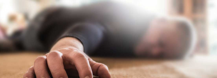 A blurry image of a man lying on the floor