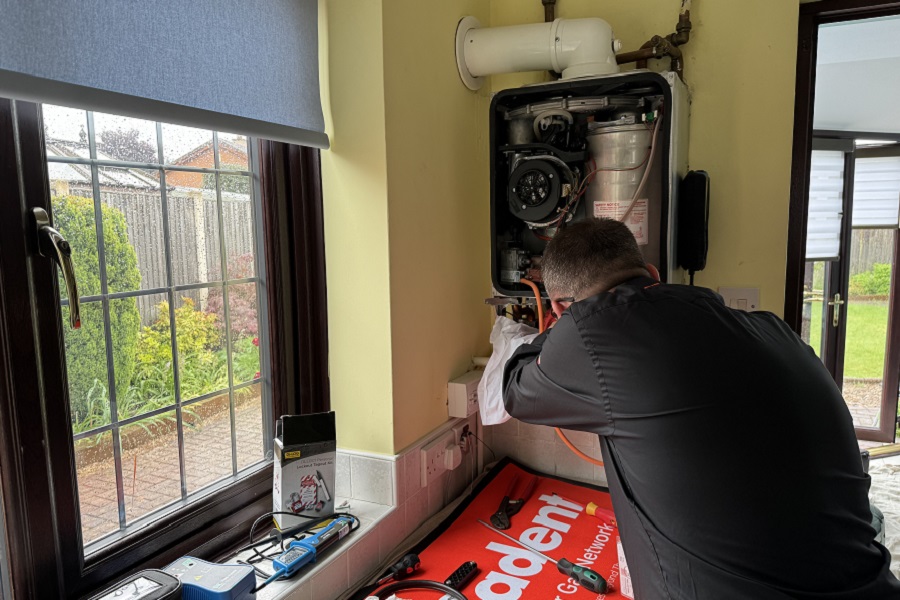 A gas engineer servicing a boiler