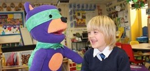 Safety Seymour engages with a child in a classroom setting