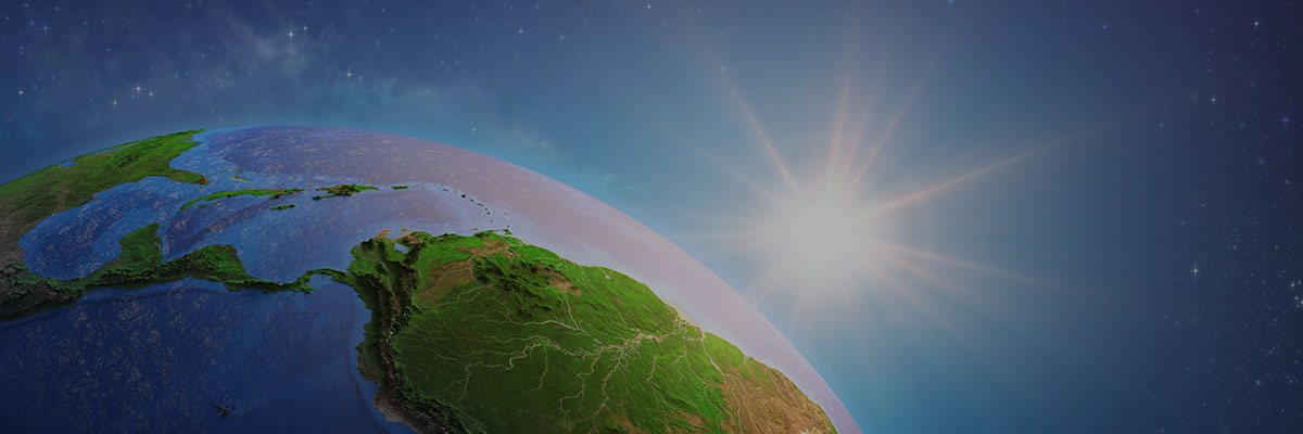 Earth's curvature with vivid land and ocean details, illuminated by the sun against a starry background.