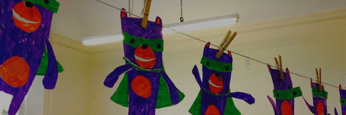 Safety Seymour cut-outs hanging on a line, attached by wooden pegs