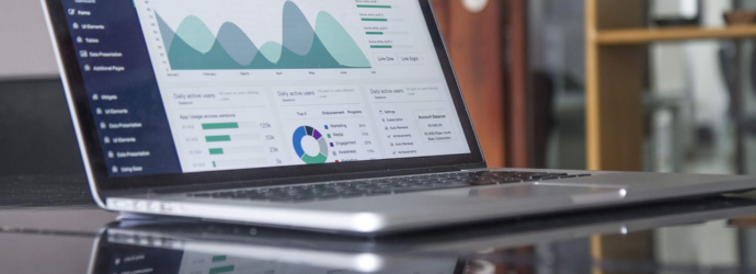 A close up of a laptop displaying a variety of graphs and bar charts. Information on what the graphs are depicting is unknown