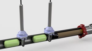 Close-up of a mechanical assembly featuring two sensors mounted on a cylindrical pipe